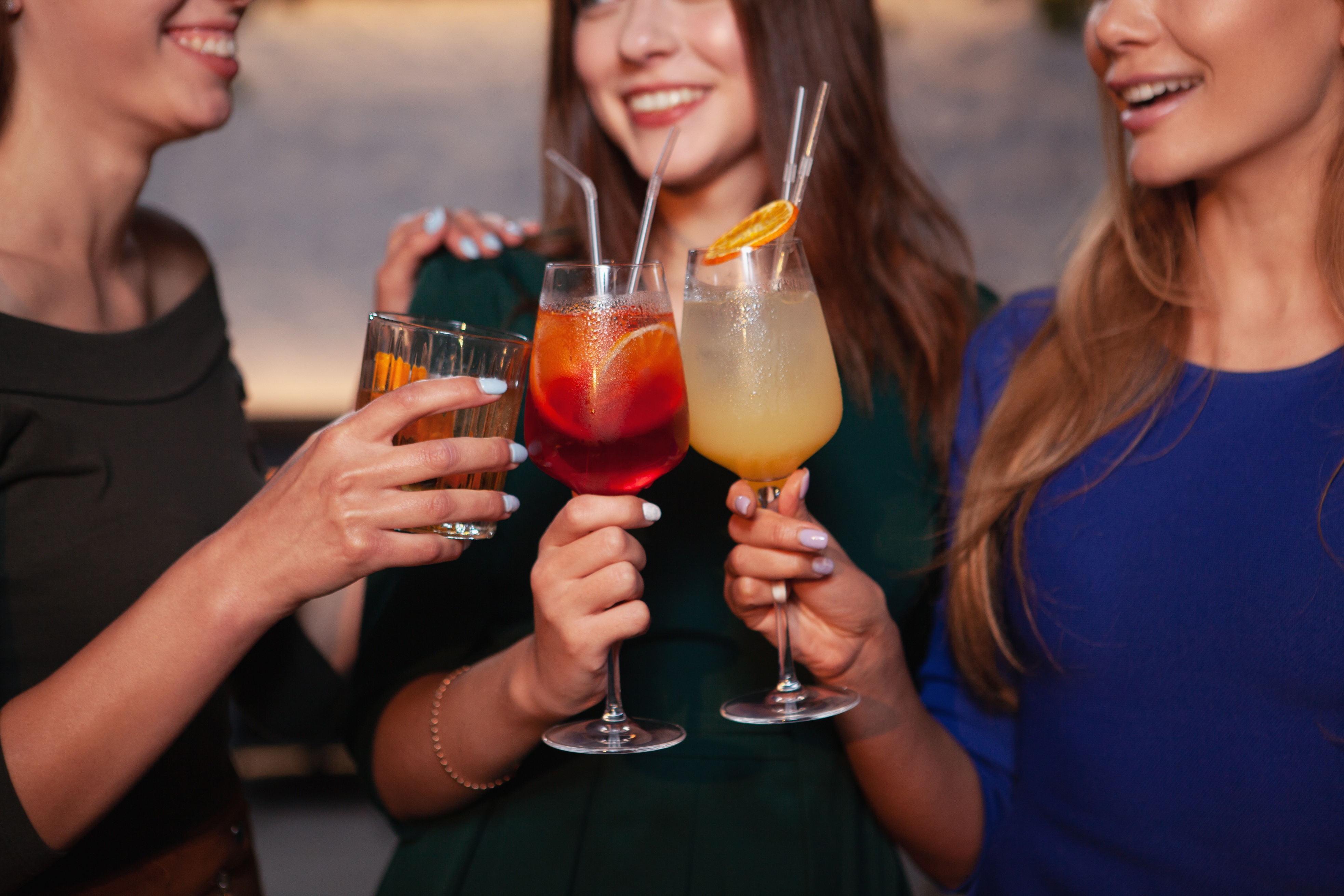 Female friends drinking at cocktail bar